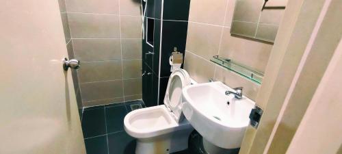 a bathroom with a toilet and a sink at Kulai d putra suites beside ioiMall near JPO and Airport in Kulai
