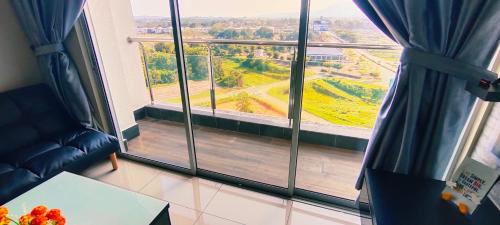a room with a large window with a view of a field at Kulai d putra suites beside ioiMall near JPO and Airport in Kulai