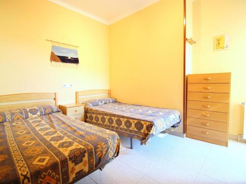 a bedroom with two beds and a dresser at Casa Palau Sabardera, 3 dormitorios, 6 personas - ES-228-139 in Palau-Saverdera