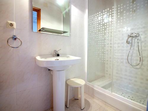 a white bathroom with a sink and a shower at Casa Palau Sabardera, 3 dormitorios, 6 personas - ES-228-139 in Palau-Saverdera