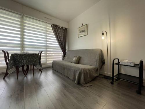 - une chambre avec un lit, une table et une chaise dans l'établissement Appartement La Rochelle, 1 pièce, 2 personnes - FR-1-246-658, à La Rochelle