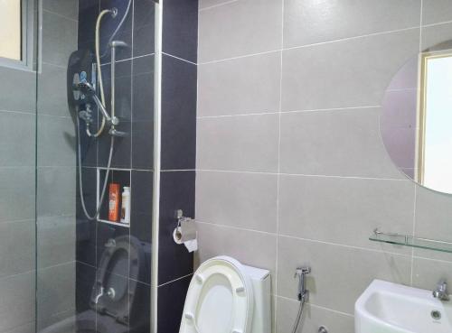 a bathroom with a shower and a toilet and a sink at Kulai d putra suites beside ioiMall near JPO and Airport in Kulai