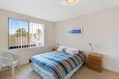 a bedroom with a bed and a window at Kamillaroi Walk to restaurants cafes and beach in Nelson Bay