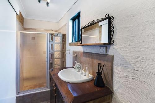 a bathroom with a sink and a mirror at Salt Wood Cabin Style Retreat in Anna Bay