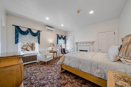 a bedroom with a bed and a chair and a window at THE GRANDEUR ESTATE in Greensburg