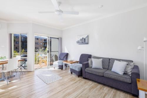 a living room with a couch and a table at Marty s Little Beach No 9 in Nelson Bay