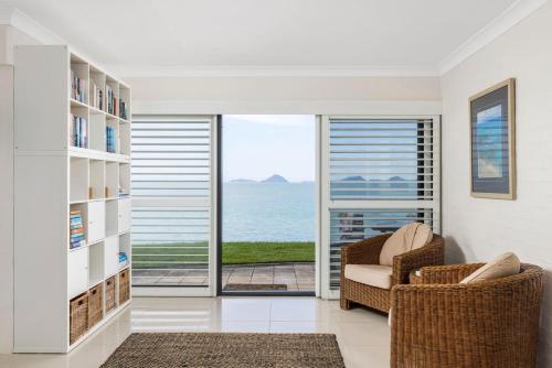 a living room with a view of the ocean at Lanimer Spectacular Waterfront in Soldiers Point