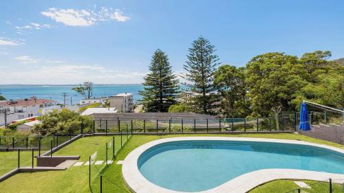 a swimming pool with a view of the water at Luxury Escape Sundeck Shoal Bay in Shoal Bay