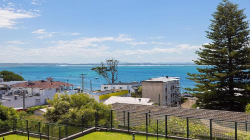 a view of a city with the ocean in the background at Luxury Escape Sundeck Shoal Bay in Shoal Bay