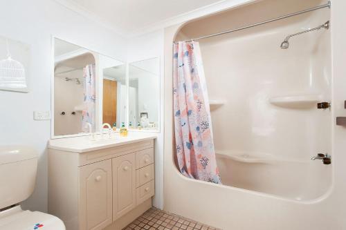 a bathroom with a toilet and a sink and a shower at Great Location in Nelson Bay in Nelson Bay