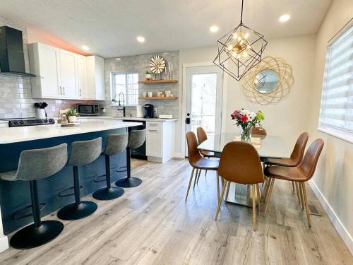 a kitchen with a table and chairs and a dining room at Modern and Spacious Home near downtown and UNL in Lincoln