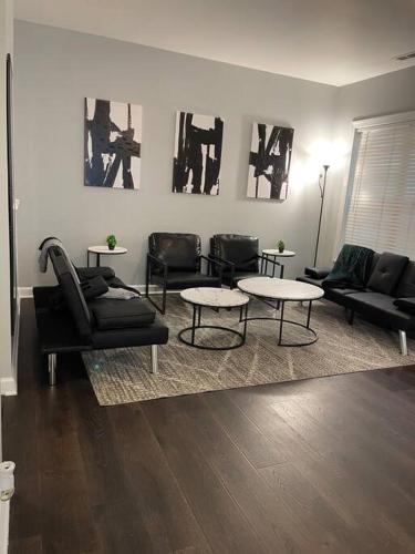 a living room with couches and chairs and tables at Simple Elegant Townhouse DT Raleigh NCSU in Raleigh