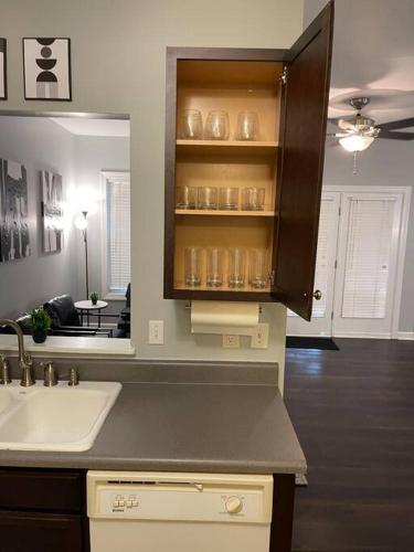a kitchen with a sink and a counter with a mirror at Simple Elegant Townhouse DT Raleigh NCSU in Raleigh