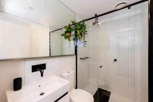 a bathroom with a sink and a toilet and a shower at COZY Melbourne Southbank - 2 Bedroom Apartment with Balcony & FREE Parking in Melbourne