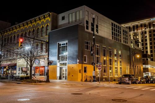 a city street at night with a traffic light and buildings at 5 King Bed Suites at The Finnley Hotel in DT GR in Grand Rapids