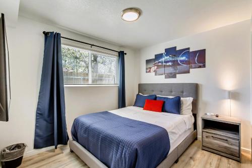 a bedroom with a bed with blue sheets and a window at Near City Center - Full Kitchen - Fast Wi-Fi in Salt Lake City