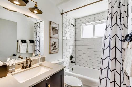 a white bathroom with a sink and a toilet at Near City Center - Full Kitchen - Fast Wi-Fi in Salt Lake City