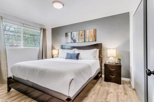 a bedroom with a large bed and a window at King Bed - Fast WiFi - Sugarhouse Health Center in Salt Lake City