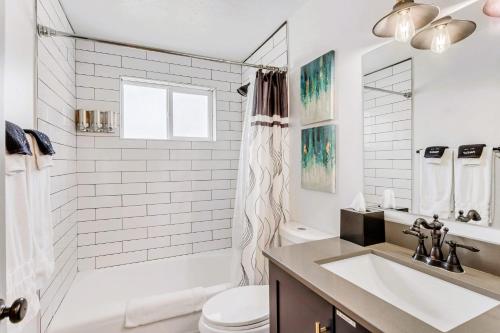 a white bathroom with a sink and a toilet at King Bed - Fast WiFi - Sugarhouse Health Center in Salt Lake City