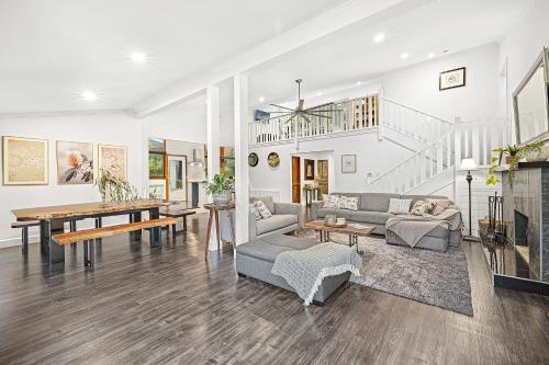 a living room filled with furniture and a table at Sherbrooke Forest Retreat - Noonameena Home in Sherbrooke