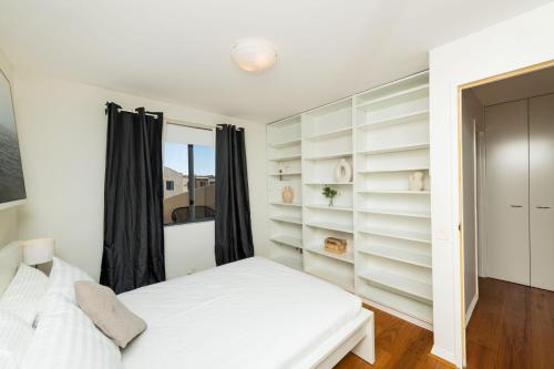 a bedroom with white shelves and a bed at Griffin 184 Kingston Apartment in Kingston 