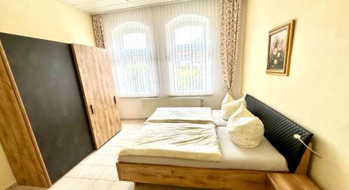 a bedroom with two beds and a window at Villa Borchert in Wernigerode