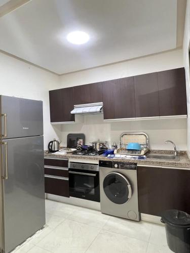 a kitchen with a washing machine and a dishwasher at Appart Studio 1 Roum Nador de luxe in Nador