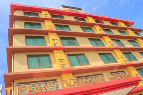 a building with a yellow and red building at Tiffany Diamond Hotels - Mtwara in Mtwara