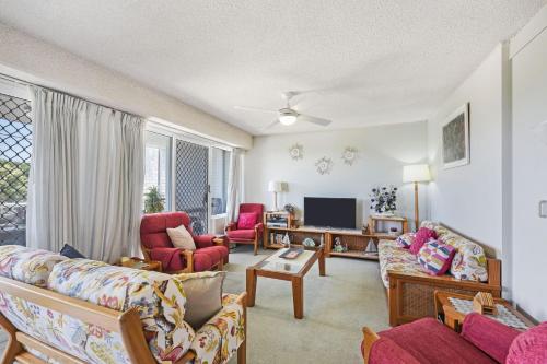 a living room with two couches and a tv at 3 Ocean Shores in Peregian Beach in Peregian Beach