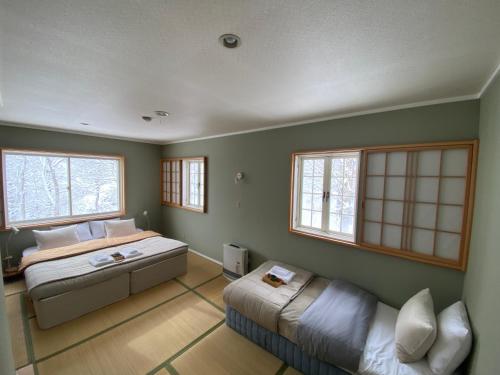 Vuode tai vuoteita majoituspaikassa Myoko Forest Lodge
