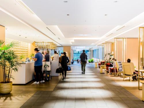 an office lobby with people walking down a hallway at Hyatt Place Kyoto in Kyoto
