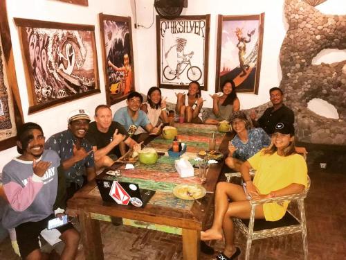 a group of people sitting around a table at 3 Waves Hotel in Huu