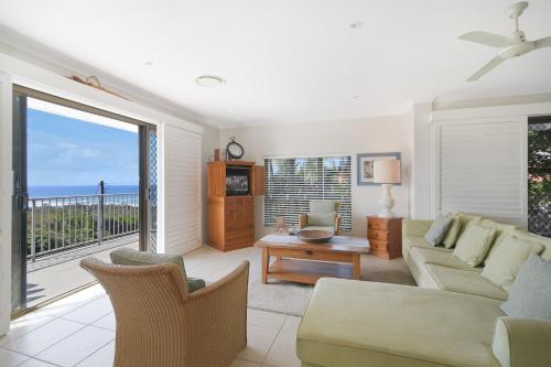 a living room with a couch and a balcony at Kari in Peregian Beach in Peregian Beach