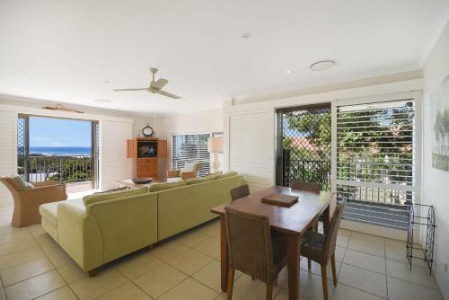 a living room with a couch and a table at Kari in Peregian Beach in Peregian Beach