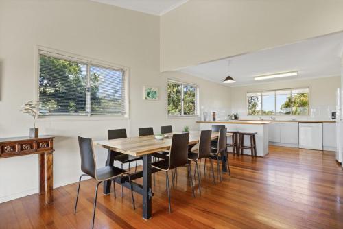 a dining room and kitchen with a table and chairs at 37 on Gouldian Court Peregian Beach in Peregian Beach