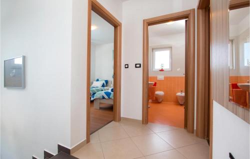 a hallway leading to a bathroom with a bedroom at 3 Bedroom Cozy Home In Loborika in Loborika