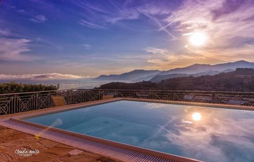 a swimming pool with a view of the mountains at Villa Gaia - Luxury Villa, pool & wellness rooms in Bordighera