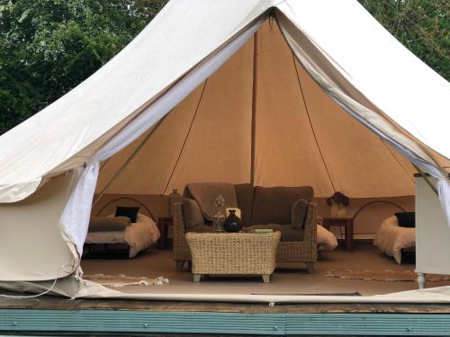 a canvas tent with chairs and a table in it at Old Oak Farm 