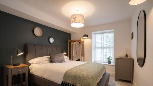 a bedroom with a bed and a large window at Bronte Apartment - Dales - Lakes - Kirkby Lonsdale in Carnforth