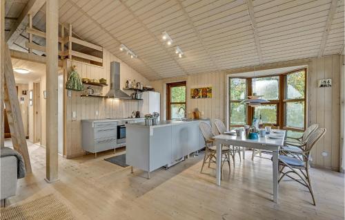 a kitchen and dining room with a table and chairs at Stunning Home In Fårvang With Wifi in Fårvang
