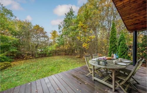 a wooden deck with a table and chairs on it at Stunning Home In Fårvang With Wifi in Fårvang