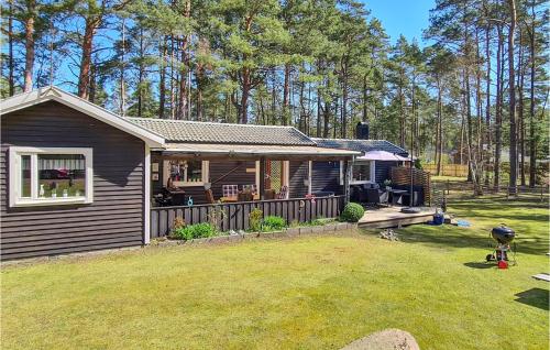 a small house with a porch and a yard at 2 Bedroom Cozy Home In Åhus in Åhus