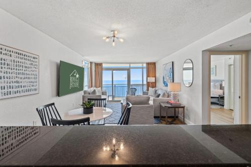a living room with a table and a living room at The Grand Myrtle BAY VIEW 1503 Full New Remodel in Myrtle Beach
