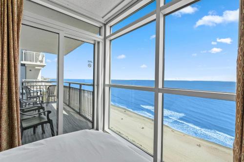 a bedroom with a view of the ocean at The Grand Myrtle BAY VIEW 1503 Full New Remodel in Myrtle Beach