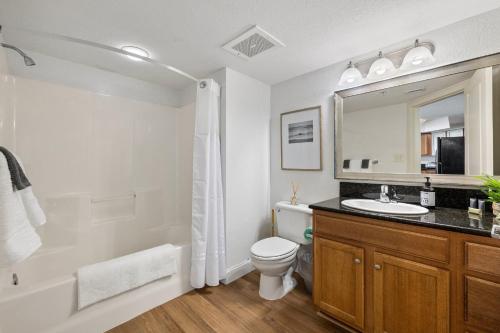 a bathroom with a sink and a toilet and a mirror at The Grand Myrtle BAY VIEW 1503 Full New Remodel in Myrtle Beach