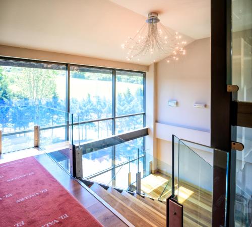 a staircase in a house with a large window at Hotel Restaurante El Valles 4 ESTRELLAS in Briviesca