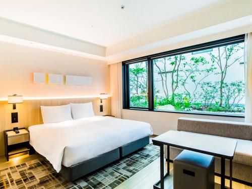 a hotel room with a bed and a window at Hyatt Place Kyoto in Kyoto
