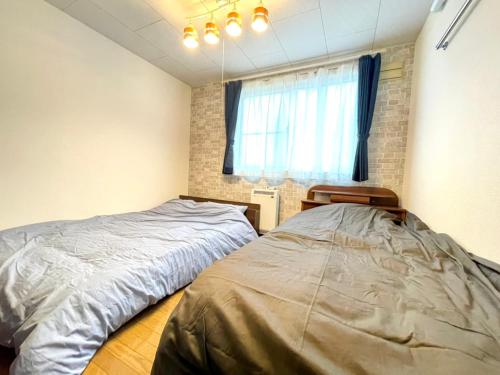 a bedroom with a bed and a window at Avidasion - Vacation STAY 13342 in Biei