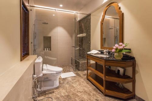 a bathroom with a toilet and a sink and a shower at Onsen at Moncham in Mae Rim