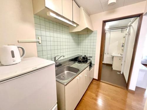 a small kitchen with a sink and a counter at Avidasion - Vacation STAY 13343 in Biei